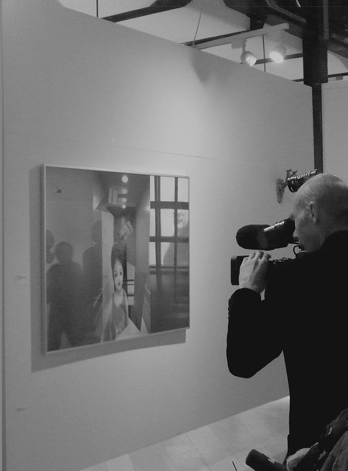 Ein Kameramann filmt in einer Ausstellungshalle ein gro&szlig;formatiges Werk von Johannes J. Dittloff an der Wand.